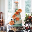 Painted peach and teal wedding cake