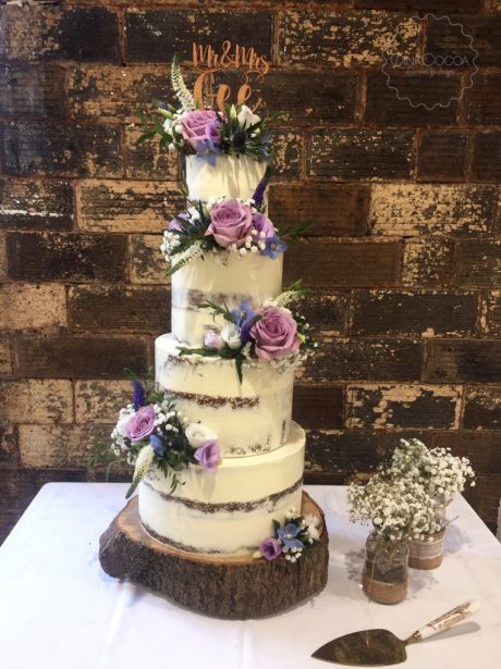 Premium AI Image | A cake with pink and purple flowers on top of it