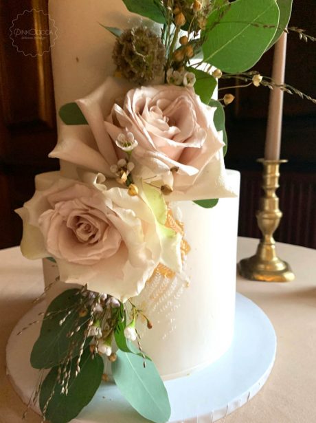 Three tier gold stencil cake with fresh flowers